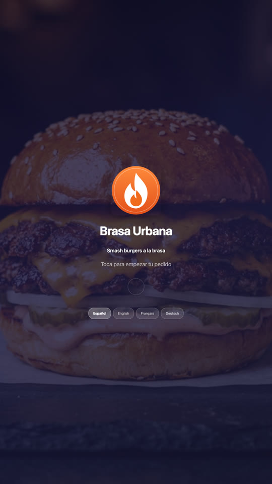 Kiosk welcome screen with a burger photo, the venue's logo, “tap to start your order” and the language buttons.